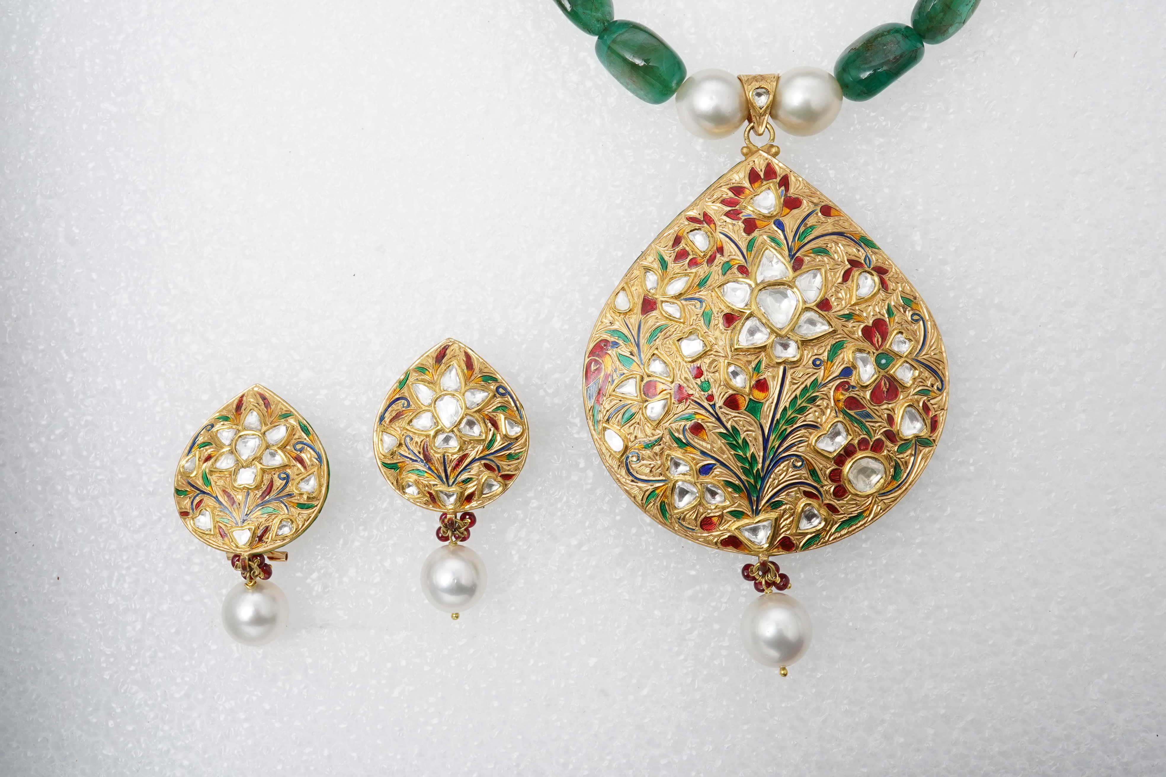 An emerald, ruby, enamel, cultured pearl and diamond demi-parure, India